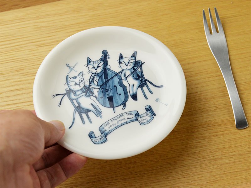 シンジカトウさんがイラストを担当　猫達がバイオリンとチェロを演奏している様子を美濃焼製のお皿に描いた商品の様子