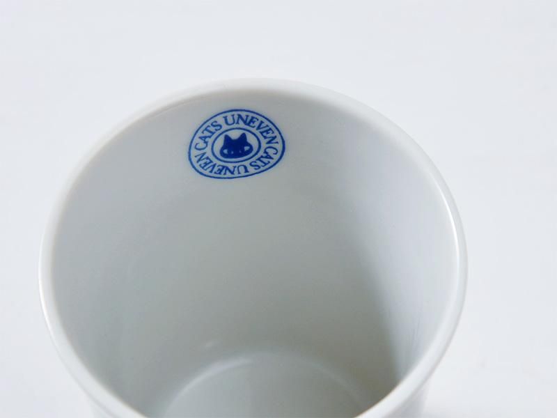 タンブラーの口元を上から写したクローズアップ写真。内側に「CATS UNEVEN」のロゴが青い文字で刻印されており、ブランド名とデザインコンセプトが読み取れます。